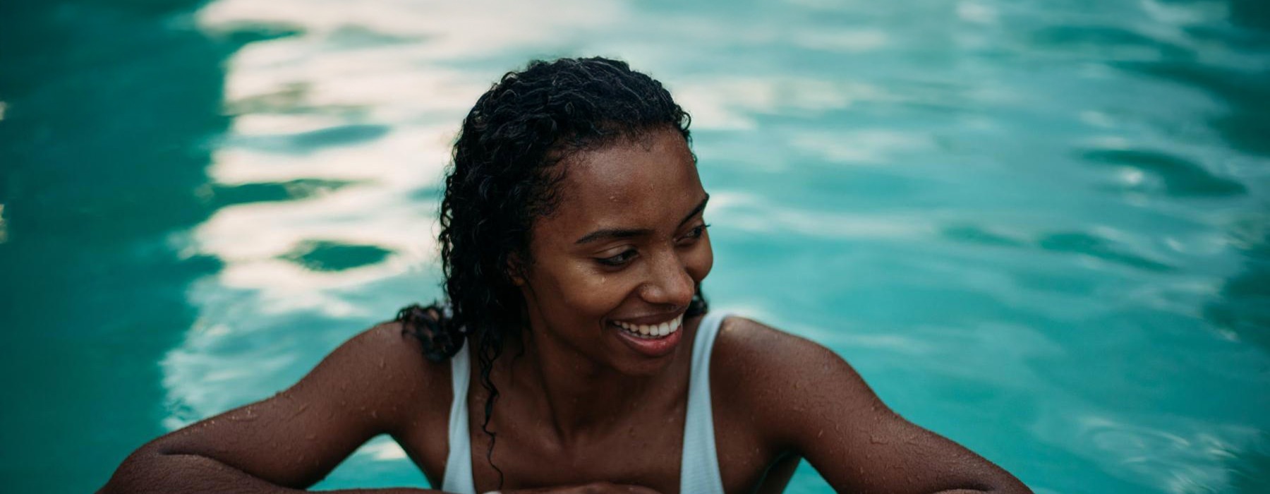 A woman standing at the end of a pool